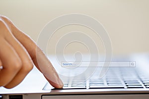 Hand people click on internet search pages on computer keyboards to find what they are interested in searching for information on