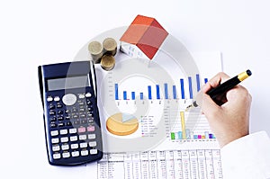 Hand people holding fountain pen on business chart and calculator with coins stack and house paper for loans concept