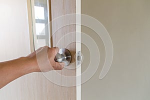 The hand of people open the door to inside ,outside door open putting into front door