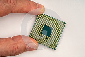 Hand of a person holding a computer processor close-up. CPU.