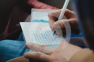 Hand of Person Writing Postcard