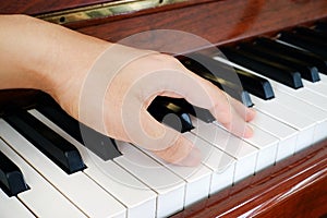 A hand on a piano