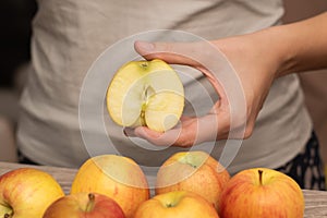 Hand Picking a Fresh Apple. Female hand holding fresh ripe apple