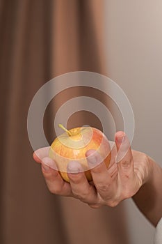 Hand Picking a Fresh Apple. Female hand holding fresh ripe apple