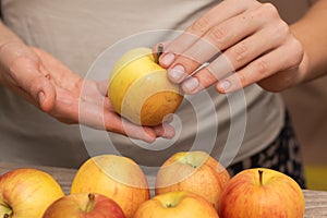 Hand Picking a Fresh Apple. Female hand holding fresh ripe apple