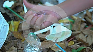 Hand picking and squashing plastic cup, threat of non-degradable microplastic