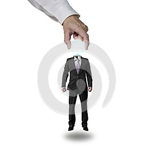 Hand picking up glowing lamp head businessman