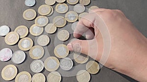 Hand picking up Indian Rupee Coins. high Angle view. Close up. Business Finance Activity Background.
