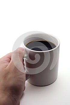 Hand picking up mug of coffee