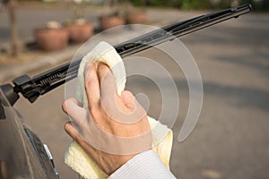 Hand picking up wiper cleaning