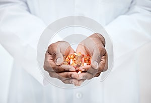 Hand, pills and doctor holding medicine for cancer treatment closeup in a medical clinic. Supplements, vitamins and