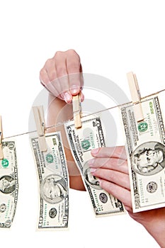 Hand pinch money on clothes line isolated