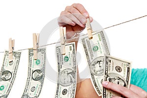 Hand pinch money on clothes line isolated