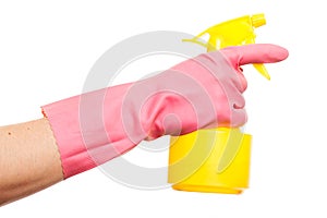 Hand in a pink glove holding spray bottle