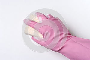 Hand in pink rubber glove is cleaning surface with sponge. Housekeeping and clean service concept.