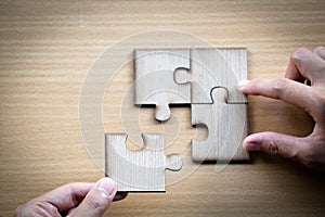 Hand placed the last piece of jigsaw puzzle, conceptual of problem solving, finding a solution