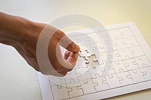 hand and jigsaw puzzle