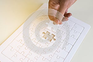 hand and jigsaw puzzle