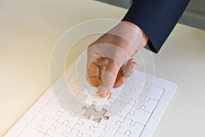 hand and jigsaw puzzle