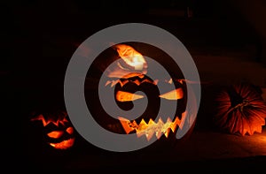 Hand placing a candle into a jack O`lantern