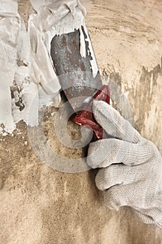 Hand plastering concrete wall with putty knife