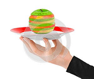 Hand with plate and chopped apple