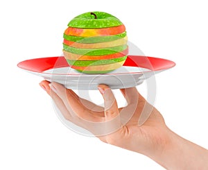 Hand with plate and chopped apple