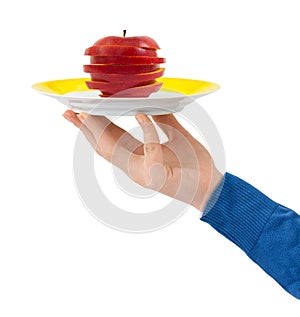 Hand with plate and chopped apple