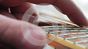 Hand playing on acoustic guitar. Macro shot of male performing beautiful melody