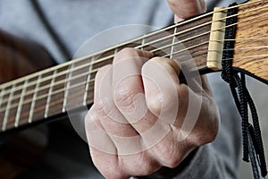 Hand Playing a D Minor Chord on Guitar
