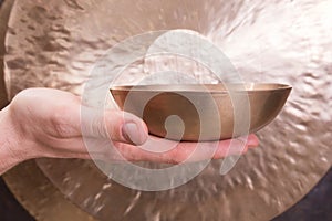 Hand playing Tibetan singing bowl