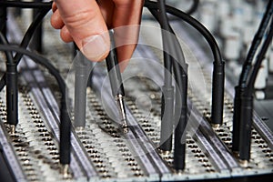 Hand Plugging Cable Into Recording Studio Patch Panel