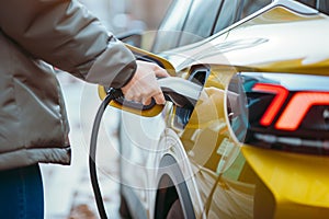Hand plugging in an electric cars charger