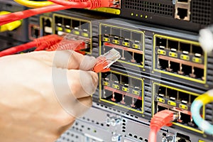 Hand Plugging Fiber Cable Into Switch In Datacenter