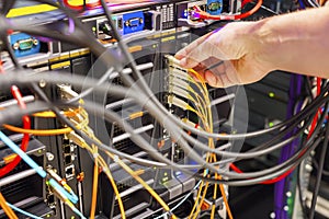 Hand Plugging Fiber Cable Into Switch In Datacenter