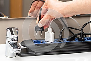 hand plugging a plug