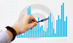 Hand pointing on a graph data