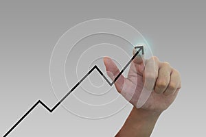 Hand pointing at increasing business graph
