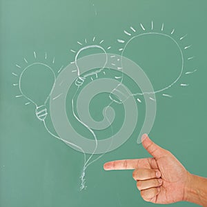 Hand pointing on light bulb drawing