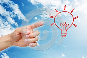 Hand pointing light bulb