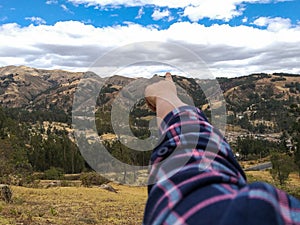 Hand pointing at the mountain photo