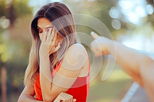 Hand Pointing to an Ashamed Young Girl Feeling Guilty