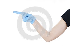 Hand pointing this way to follow. Hand in a disposable latex blue glove. Woman`s hand gesture or sign.