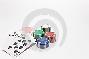 Hand of poker, Royal flush of spades, chips on white background