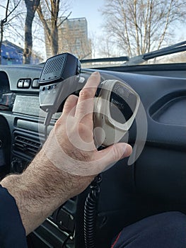 The hand of a policeman holds the tangent of a radio station