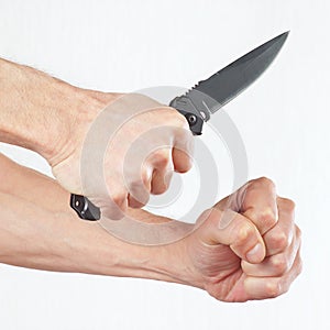 Hand position to attack with a army knife on white background