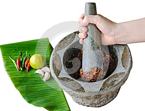 Hand pounding shrimp paste chilli sauce in mortar