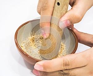 Hand pounding white sesame