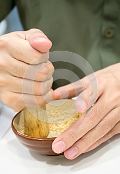 Hand pounding white sesame photo