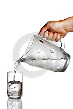 Hand pouring water from glass jug